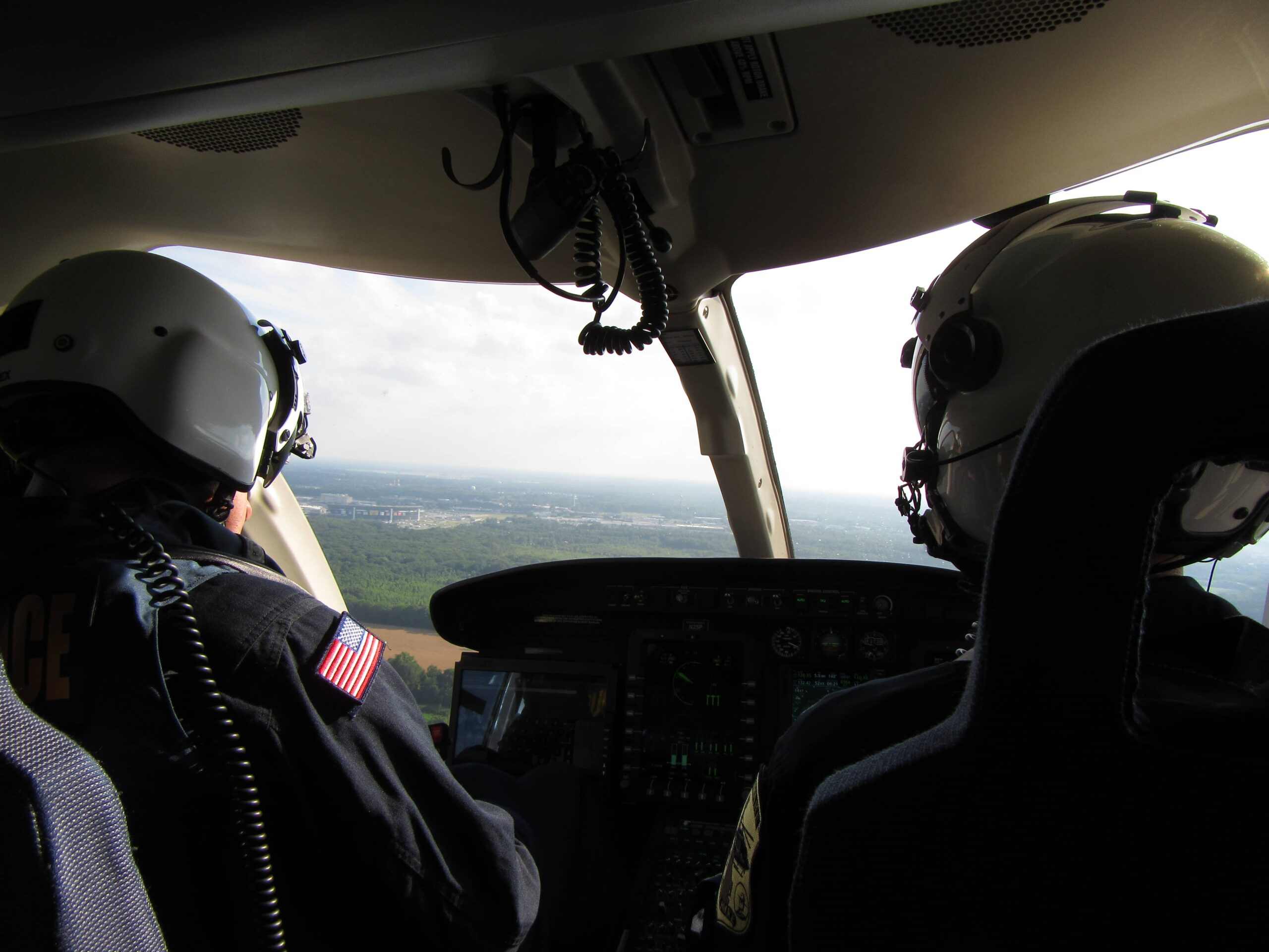 Two pilots flying helicopter in Delaware, USA. Photo taken by ADRIDEN Global Inc.